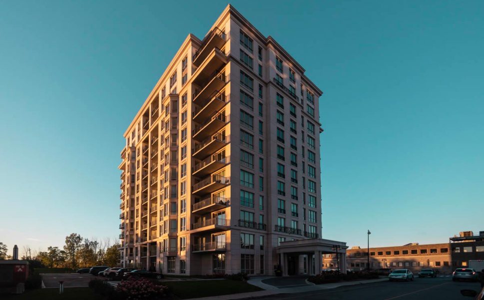 High-end residential building in Laval with balconies and elegant entrance at sunset