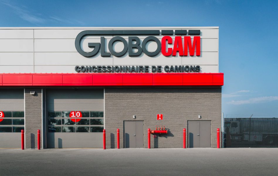 Facade of Globocam truck dealership in Quebec with sign and numbered garage doors