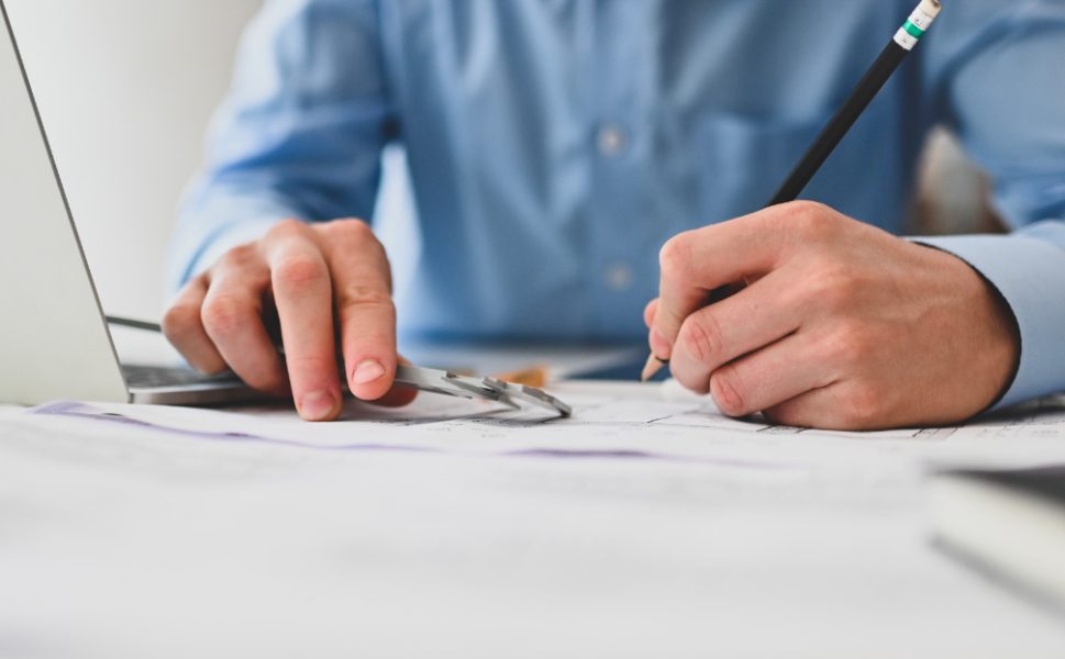 Architect drawing design plans for door manufacturing at Portes Saint-Michel