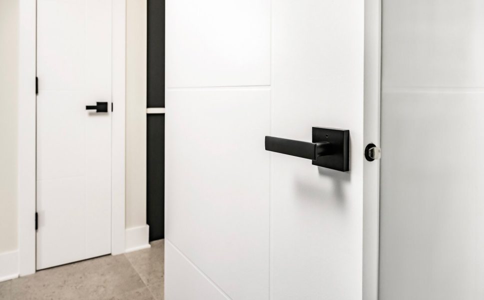 Modern white interior door with sleek black square handle design